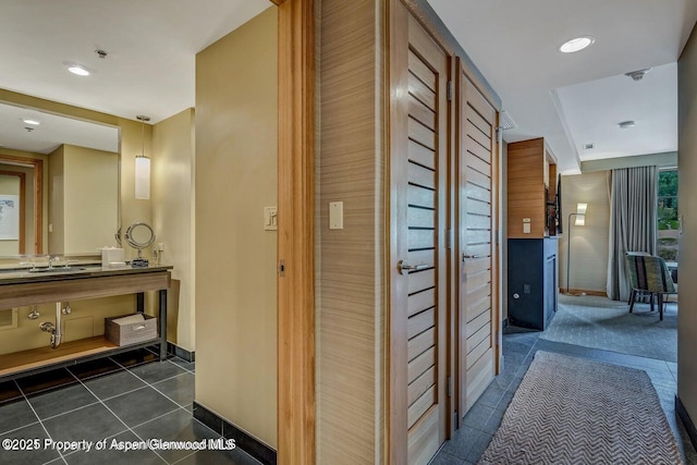130 Wood Rd Unit 625, Snowmass Village, CO 81615 - hallway featuring dark tile patterned flooring and a sink