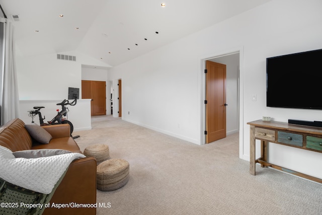 living area with baseboards, high vaulted ceiling, visible vents, and light colored carpet