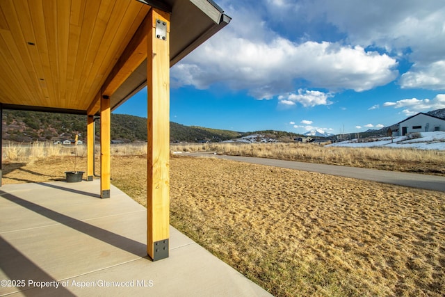 view of patio / terrace featuring a mountain view