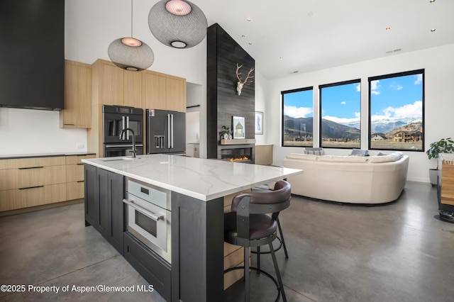 kitchen with concrete floors, modern cabinets, and light brown cabinetry