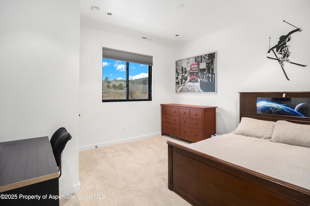 bedroom featuring baseboards and light colored carpet