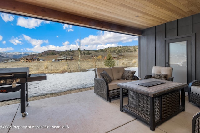 view of patio / terrace with a mountain view and an outdoor hangout area