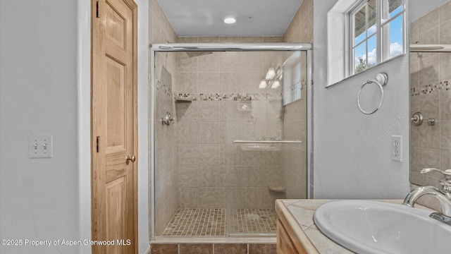 full bath featuring a stall shower and vanity