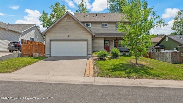 traditional home with driveway, fence, and a front yard