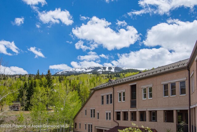 425 Wood Rd Unit 48, Snowmass Village, CO 81615 - view of building exterior featuring a view of trees and a mountain view