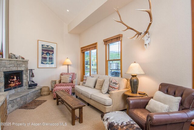 425 Wood Rd Unit 48, Snowmass Village, CO 81615 - living room with a stone fireplace, carpet, and high vaulted ceiling