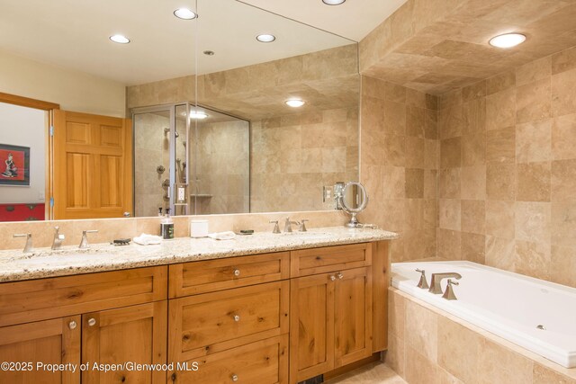 425 Wood Rd Unit 48, Snowmass Village, CO 81615 - bathroom featuring double vanity, a garden tub, tile walls, recessed lighting, and a stall shower