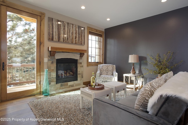 living room with a fireplace and light wood-type flooring