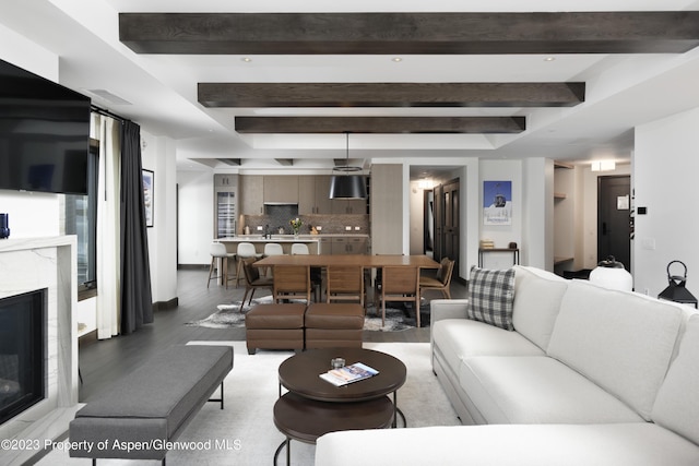 65 Wood Rd Unit 233, Snowmass Village, CO 81615 - living room with light wood finished floors, a glass covered fireplace, and beamed ceiling