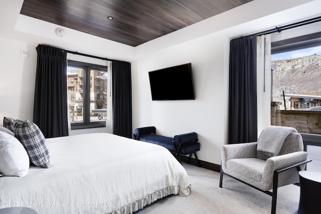 65 Wood Rd Unit 233, Snowmass Village, CO 81615 - bedroom with multiple windows, carpet floors, wood ceiling, and a raised ceiling