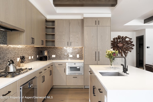 65 Wood Rd Unit 233, Snowmass Village, CO 81615 - kitchen with stainless steel gas stovetop, wood finished floors, wall oven, and light countertops