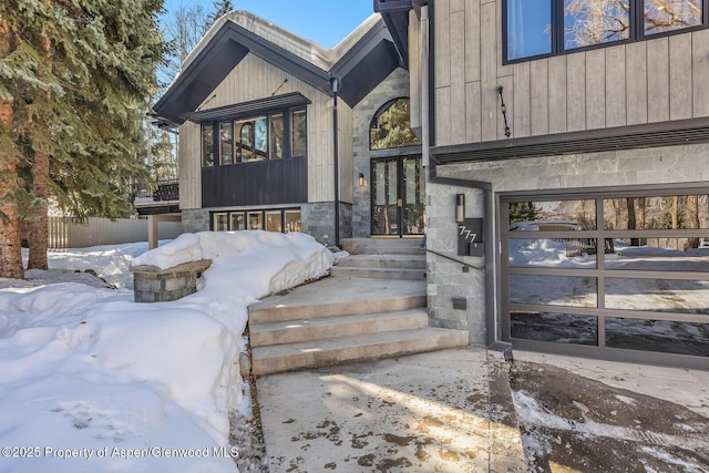 view of snow covered property entrance