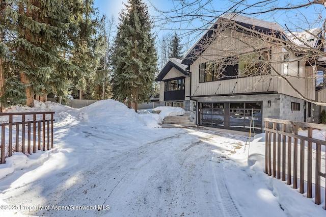 view of snowy exterior with a garage