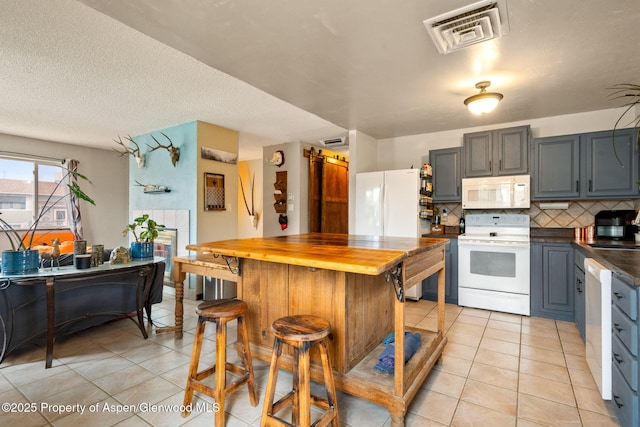 2533 E Ave, Rifle, CO 81650 - kitchen with white appliances, wood counters, light tile patterned floors, tasteful backsplash, and a textured ceiling