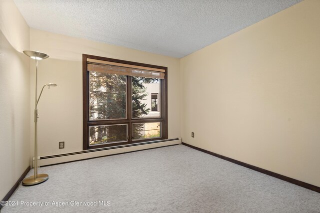 211 Meadow Ranch Dr Unit D5A, Snowmass Village, CO 81615 - carpeted spare room featuring baseboard heating, baseboards, and a textured ceiling