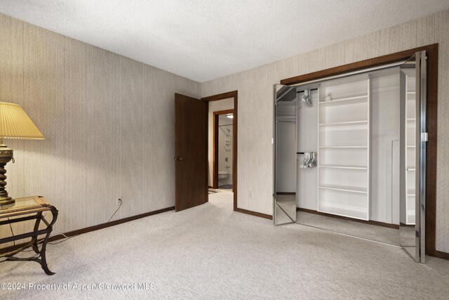 211 Meadow Ranch Dr Unit D5A, Snowmass Village, CO 81615 - bedroom featuring carpet floors, baseboards, a closet, and a textured ceiling
