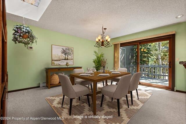 211 Meadow Ranch Dr Unit D5A, Snowmass Village, CO 81615 - carpeted dining area featuring a chandelier, baseboard heating, baseboards, a textured ceiling, and a skylight