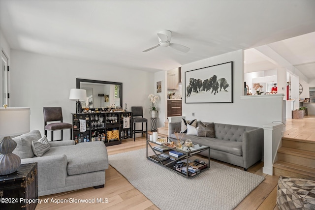 living room featuring ceiling fan and light wood-type flooring