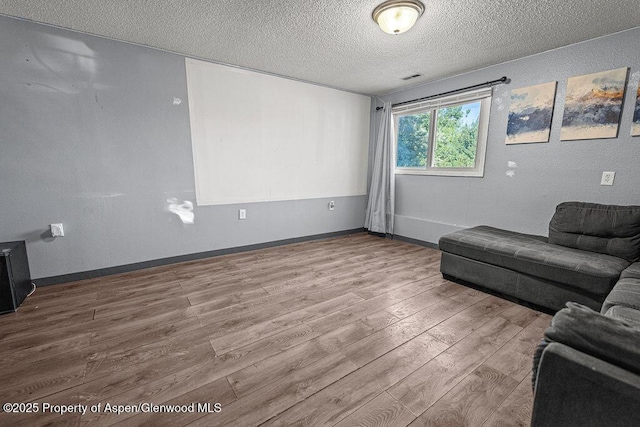 714 Westridge Rd, Craig, CO 81625 - living room featuring a textured ceiling and wood finished floors