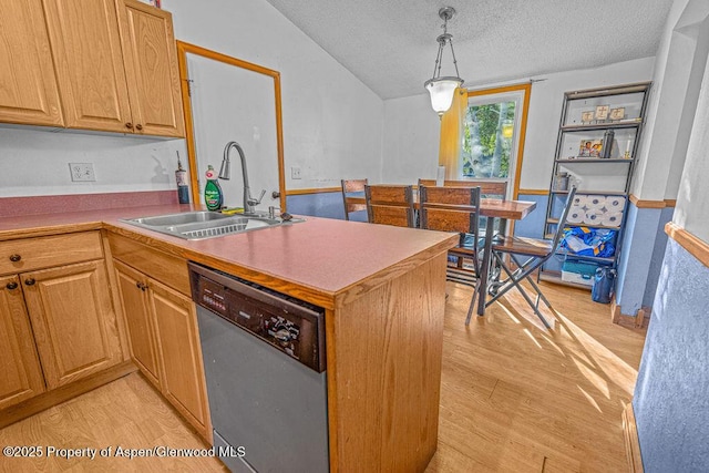 714 Westridge Rd, Craig, CO 81625 - kitchen featuring stainless steel dishwasher, a peninsula, a textured ceiling, light wood finished floors, and vaulted ceiling