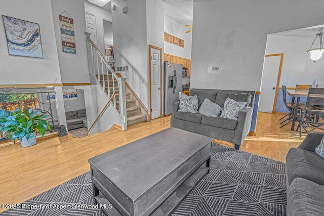 714 Westridge Rd, Craig, CO 81625 - living area featuring wood finished floors, stairs, and a high ceiling