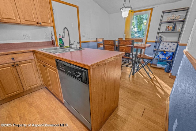 714 Westridge Rd, Craig, CO 81625 - kitchen featuring stainless steel dishwasher, light wood-style floors, a peninsula, hanging light fixtures, and a textured ceiling