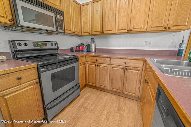 714 Westridge Rd, Craig, CO 81625 - kitchen featuring stainless steel appliances, light wood-style flooring, and brown cabinetry