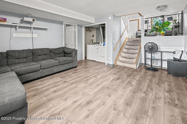 714 Westridge Rd, Craig, CO 81625 - living area featuring independent washer and dryer, wood finished floors, stairway, and a textured ceiling