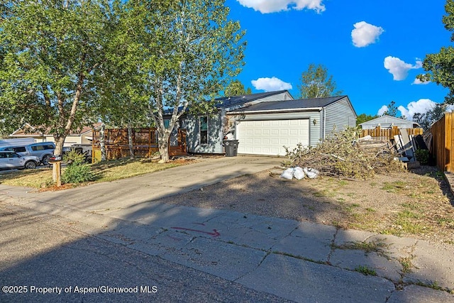 714 Westridge Rd, Craig, CO 81625 - view of front of home with driveway, an attached garage, and a metal roof