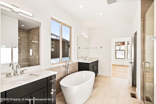 bathroom with vanity, plus walk in shower, and tile patterned flooring