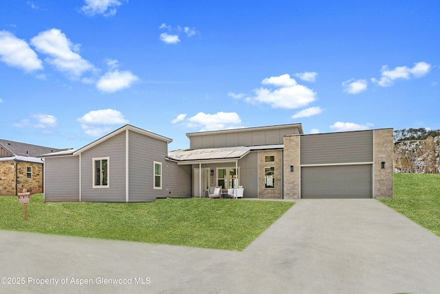 contemporary house with a garage and a front yard