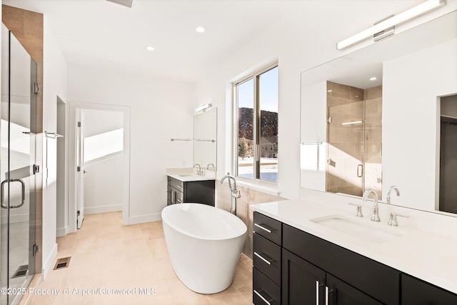 bathroom featuring tile patterned flooring, vanity, and separate shower and tub