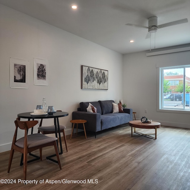 living room with hardwood / wood-style flooring and ceiling fan