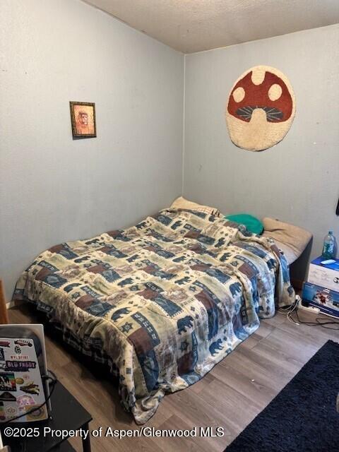 bedroom featuring wood finished floors