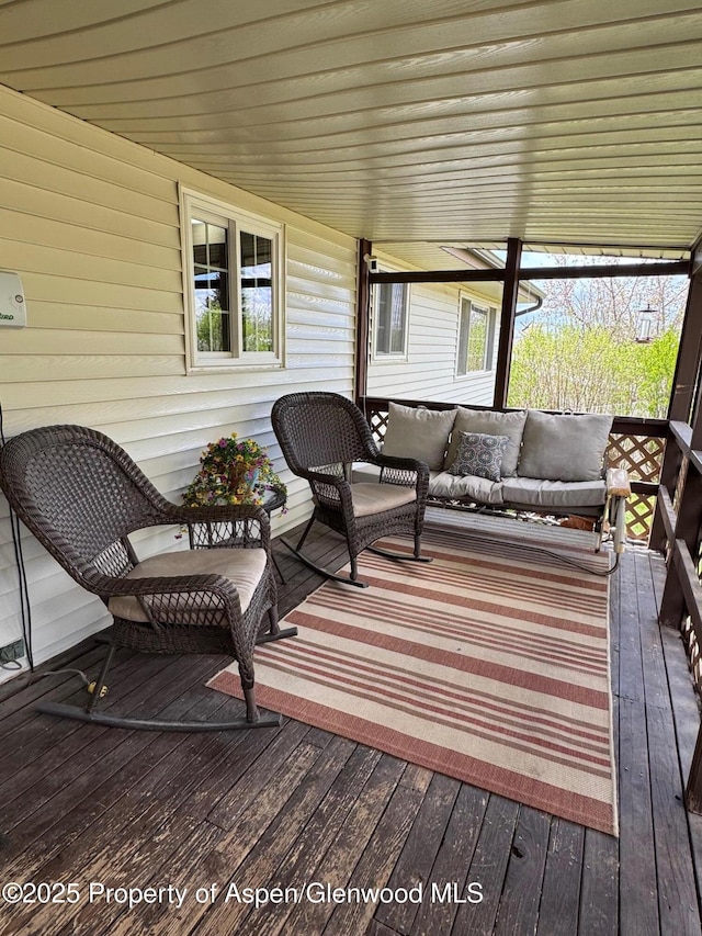 wooden terrace featuring an outdoor hangout area