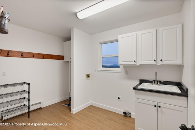 laundry area with baseboards, a sink, washer hookup, light wood-style floors, and a baseboard heating unit