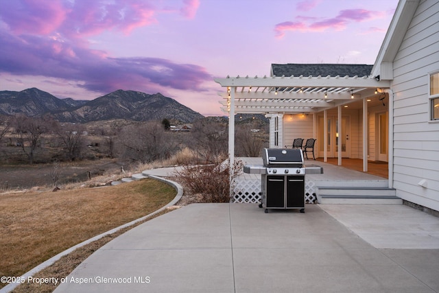 view of patio / terrace featuring area for grilling, a mountain view, and a pergola