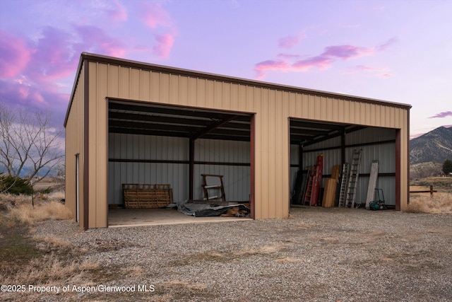 outdoor structure at dusk with an outbuilding and a pole building