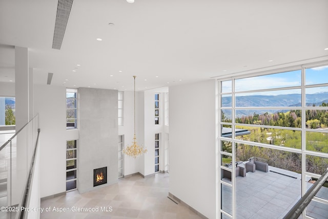 401 Eagle Park Dr, Aspen, CO 81611 - hall featuring expansive windows, a mountain view, healthy amount of natural light, recessed lighting, and baseboards