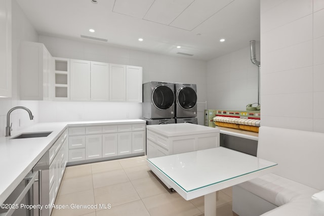 401 Eagle Park Dr, Aspen, CO 81611 - washroom featuring independent washer and dryer, light tile patterned floors, recessed lighting, and cabinet space