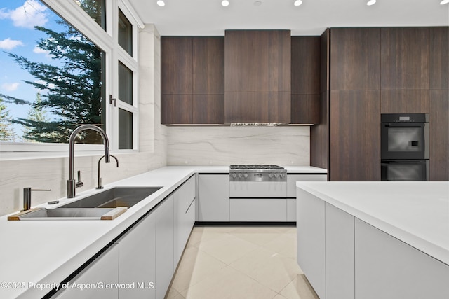 401 Eagle Park Dr, Aspen, CO 81611 - kitchen featuring a sink, modern cabinets, light countertops, decorative backsplash, and recessed lighting