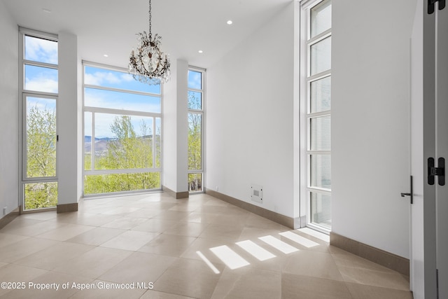 401 Eagle Park Dr, Aspen, CO 81611 - unfurnished dining area featuring a chandelier, baseboards, a high ceiling, light tile patterned floors, and recessed lighting