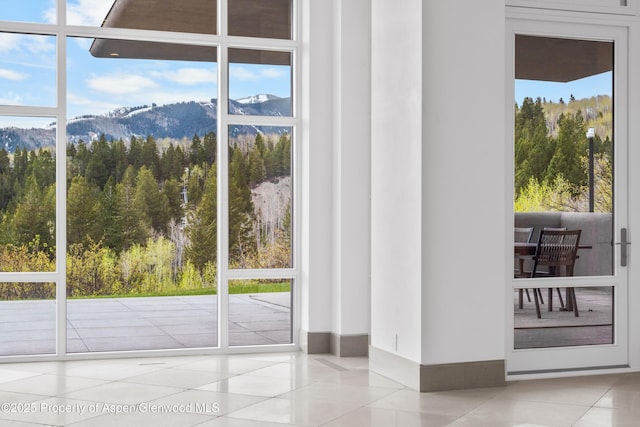 401 Eagle Park Dr, Aspen, CO 81611 - doorway featuring tile patterned flooring, a mountain view, a view of trees, and healthy amount of natural light