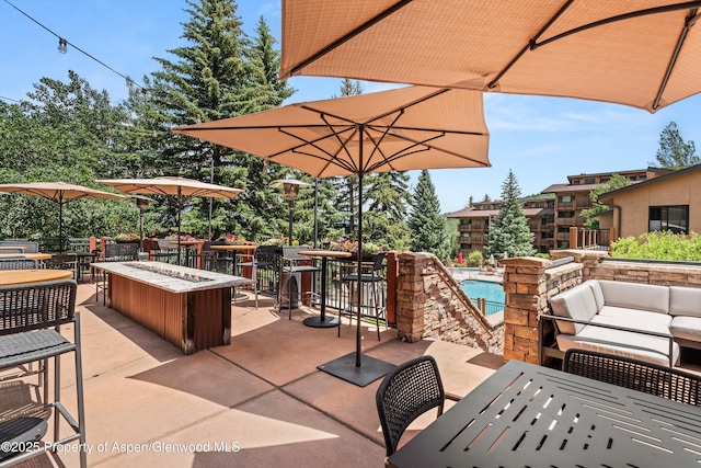 300 Carriage Way 623 & 625, Snowmass Village, CO 81615 - view of patio / terrace featuring outdoor dining area, a community pool, and an outdoor living space with a fire pit