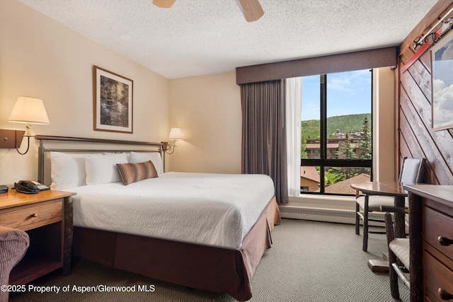 300 Carriage Way 623 & 625, Snowmass Village, CO 81615 - carpeted bedroom featuring ceiling fan, a textured ceiling, and baseboard heating