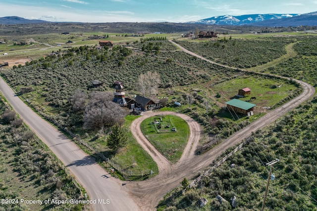 birds eye view of property featuring a mountain view and a rural view