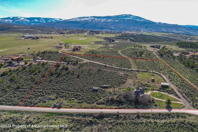 drone / aerial view featuring a mountain view and a rural view