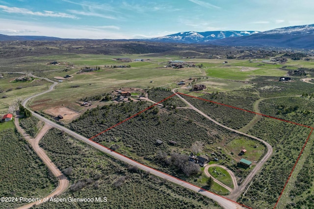 drone / aerial view with a mountain view and a rural view