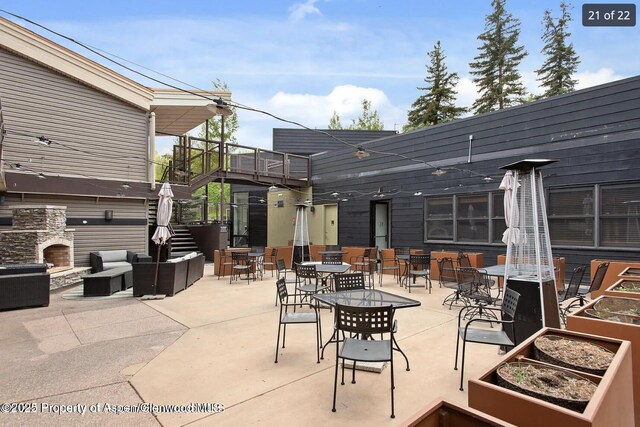 690 Carriage Way Unit D3D, Snowmass Village, CO 81615 - view of patio / terrace with an outdoor living space with a fireplace and outdoor dining area
