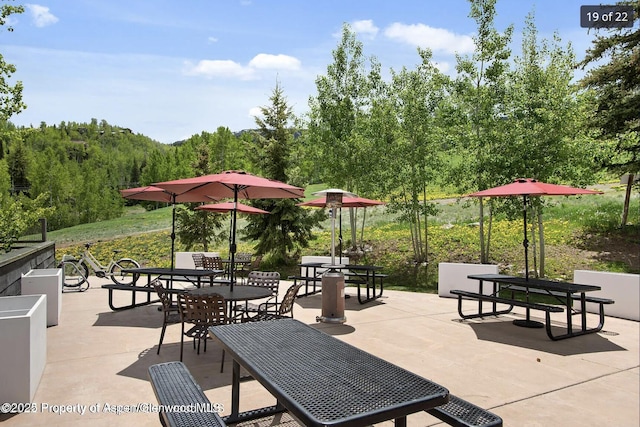690 Carriage Way Unit D3D, Snowmass Village, CO 81615 - view of property's community with a patio, outdoor dining area, and a forest view